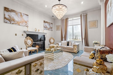 Living room featuring a glass covered fireplace, r