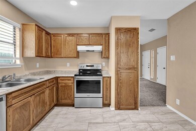 Kitchen with light countertops, visible vents, ap