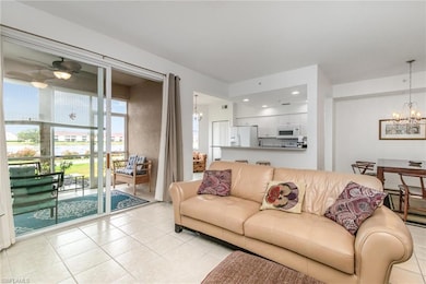 Living area featuring a chandelier, light tile patterned floors, and a ceiling fan