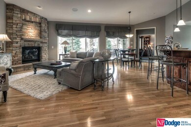 Open flow of living/dining areas offers smooth vaulted ceilings, gorgeous wood flooring, a full wall of windows, and warm stone fireplace for cozy gatherings. Main floor also has ceiling mounted upgraded stereo speakers.