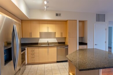 Kitchen with a sink, visible vents, light tile pa