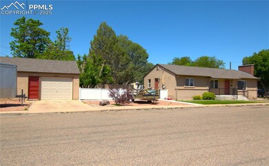 Ranch-style home featuring stucco siding, concrete driveway, and detached garage