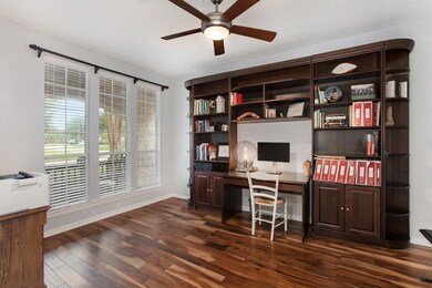 Study with wood floors, built-ins and a ceiling fan has a great view to the front yard.