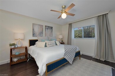 Bedroom with ceiling fan and hardwood / wood-style