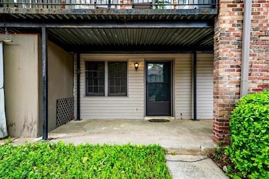 View of exterior entry featuring a balcony and a patio