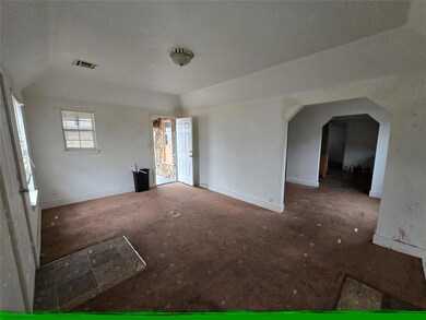 Unfurnished room with vaulted ceiling