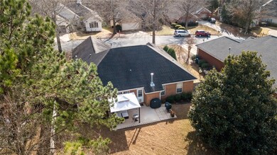 Spacious backyard with patio and anchored pergola.