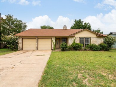Single story home featuring stone siding, a garag
