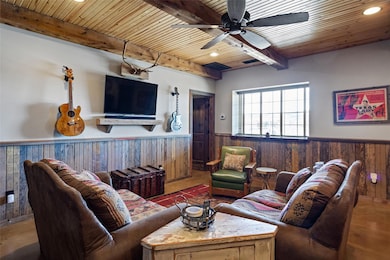 Living room with a beam ceiling, recessed lighting