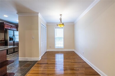 Dining area with open way to kitchen and wood fini