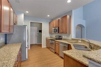 Kitchen with stainless steel appliances, light woo