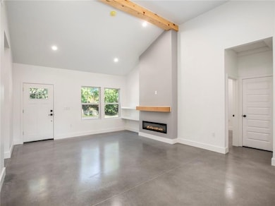 Living room with beamed ceiling and kitchen