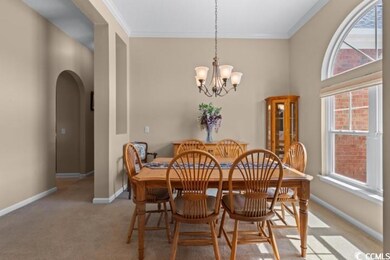 Dining space featuring light colored carpet, an in