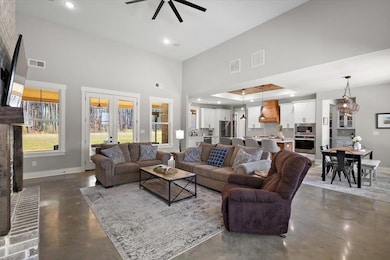 Living room featuring concrete floors, visible ven