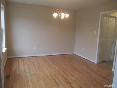 Formal Dining Room with hardwood flooring.