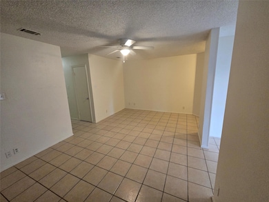 Unfurnished room featuring ceiling fan, light til