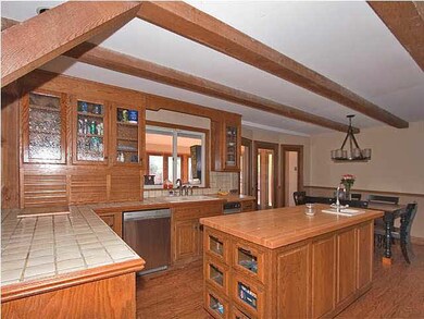 large kitchen with center isle, hardwood floors, b
