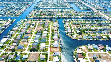 Birds eye view of property with a water view and a