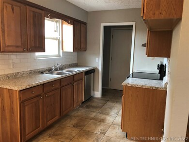 Kitchen with new counter tops & new backsplash.