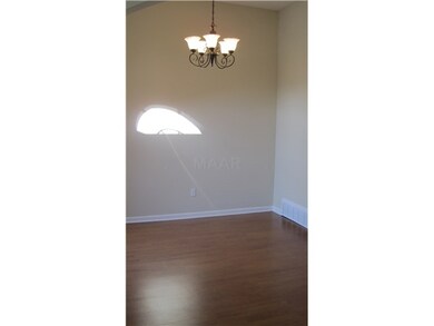 Formal dining room has a picutre window and a large archway from the hall.