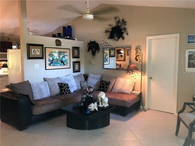 Living room with soaring ceilings and tiled.