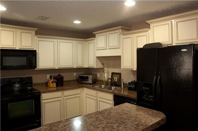 A view of the very functional kitchen.  The refrigerator dishwasher range and microwave are all part of the sale.