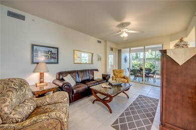 Living room with ceiling fan and light tile patter