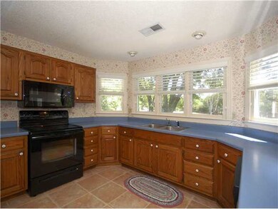Spacious kitchen with lots of windows for lighting