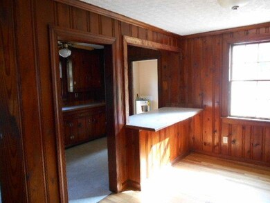 The dining area has an easy view of the kitchen, m