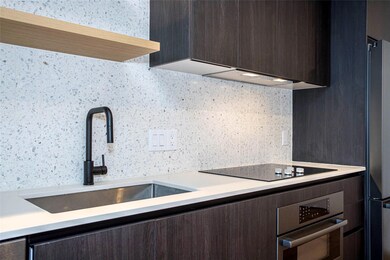 Kitchen featuring black appliances, a sink, dark 