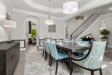 Dining room with tray ceiling and chair railing