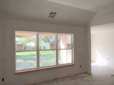 High ceiling in living room with wall of windows t