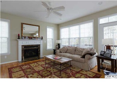 Family room has a ceiling fan and opens to a large