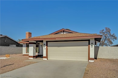 Ranch-style home featuring driveway, a garage, stucco siding, and a chimney