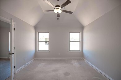 Spare room with ceiling fan and vaulted ceiling