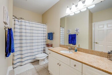 Bathroom with tile patterned flooring, curtained s