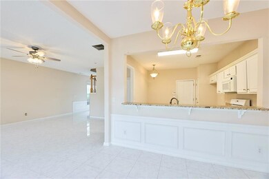 Kitchen featuring white microwave, light stone cou