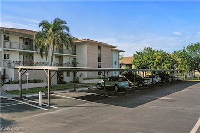 View of building exterior with covered carport spa