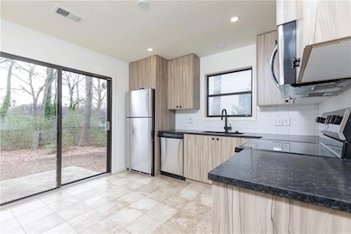 Kitchen with new cabinetry and stainless-steel app