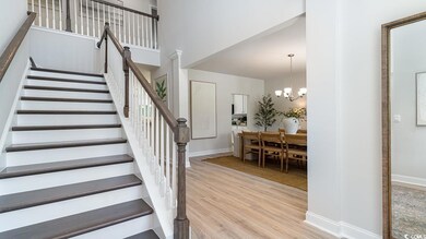 Staircase with hardwood / wood-style floors and a 
