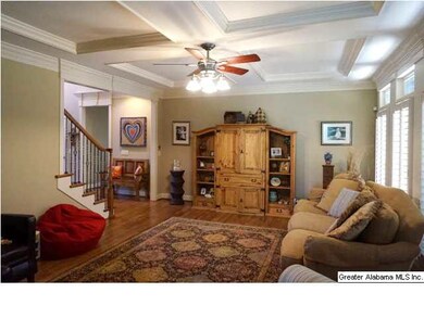 Family room has coffered ceilings, plantation shut