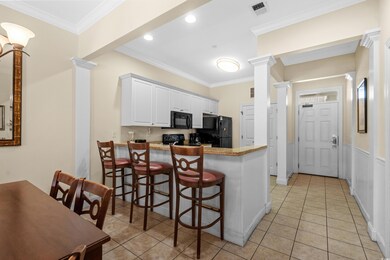 Kitchen featuring a breakfast bar, black appliance
