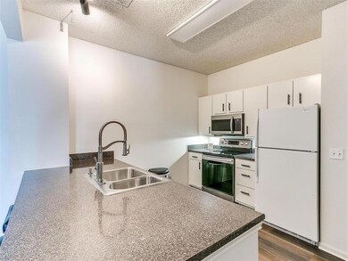 Kitchen with a peninsula, wood finished floors, a 