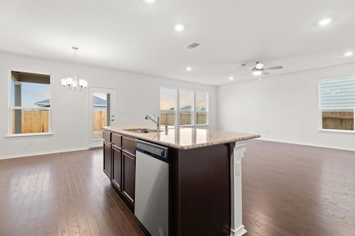 Kitchen with dishwashing machine, a sink, open fl