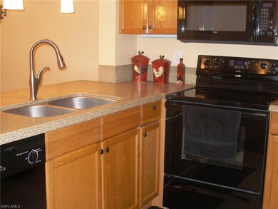The spacious kitchen features hardwood cabinetry, 