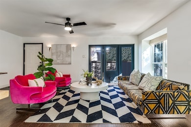 Living area featuring wood finished floors and ceiling fan