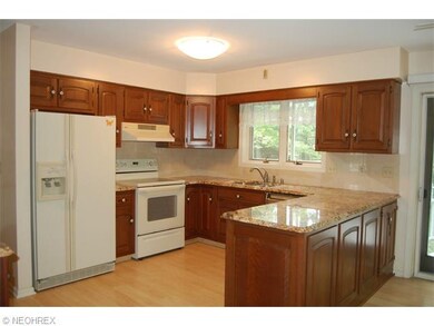 Newer appliances including side by side refrigerator, laminate flooring, contemporary faucet, and wonderful view of back yard out kitchen window.