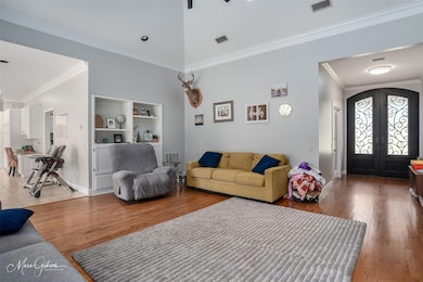 Living room with hardwood flooring, ornamental mol