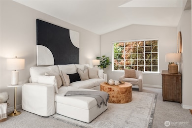 The formal living room is one of 3 different lounge areas and features vaulted ceilings, new paint and new carpet.