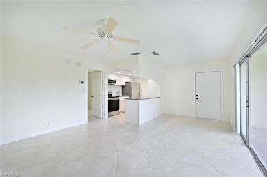 Unfurnished living room with a ceiling fan and light tile patterned floors